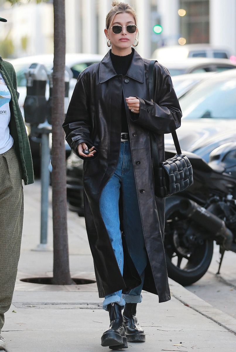 Hailey Bieber wearing long length leather coat and chunky boots