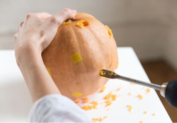 Carving pumpkin for Halloween using a drill