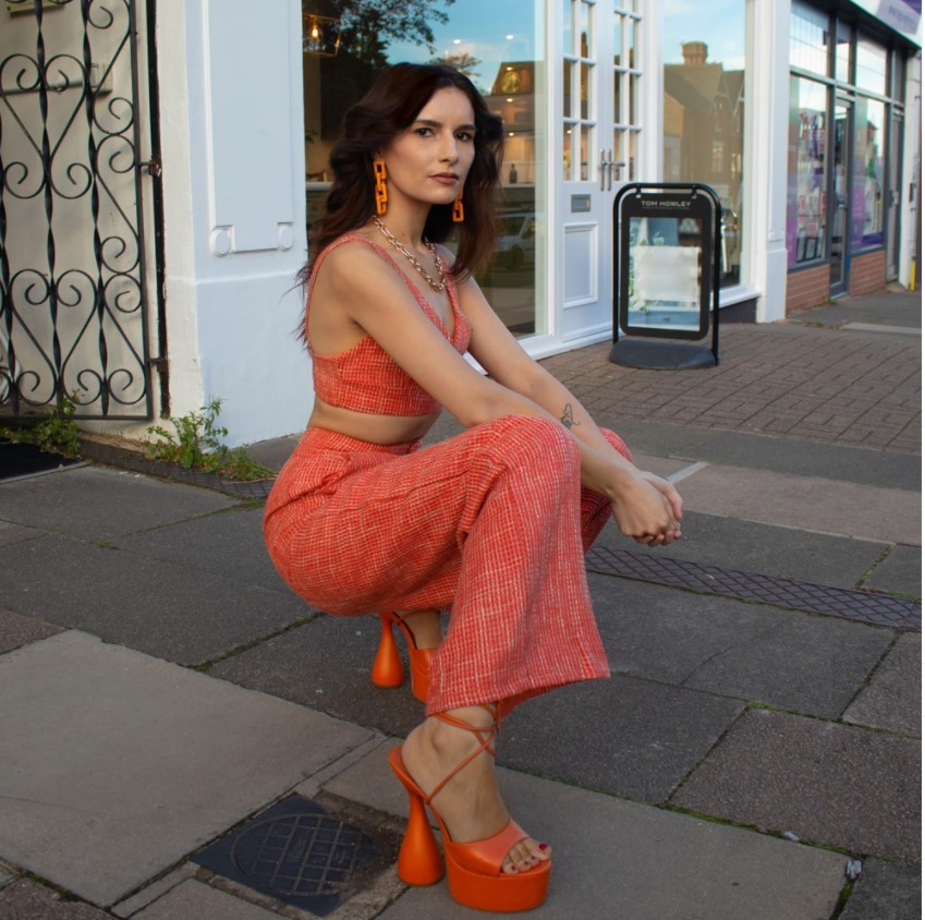 Influencer @amiizmus wearing orange wide leg trousers and bralette co-ord with orange Lace Up Sandal Heels.